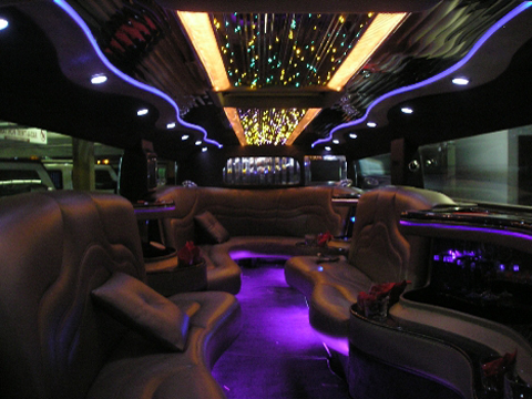 White wedding limo in front of a Houston wedding venue